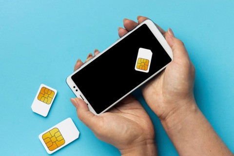 Front view hands holding smartphone sim cards