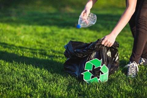 Recycle concept with woman collecting trash