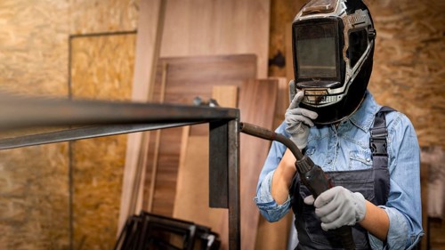 Front view woman with welding tool mask