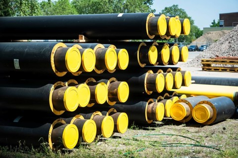 A stack of new pipes for district heating at a construction site in Duesseldorf