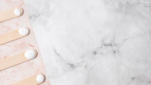 Wooden sticks with cream marble background