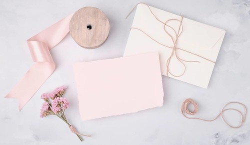 Flat lay lovely arrangement with wedding invitations