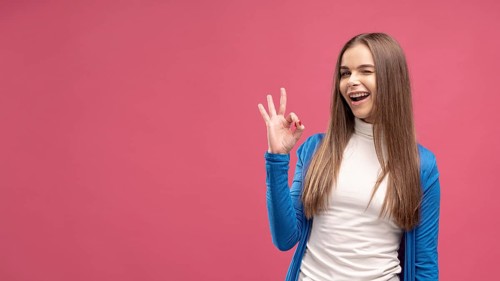 Front view woman winking giving ok sign