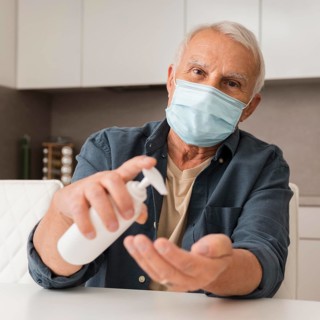 Front view man with mask disinfectant