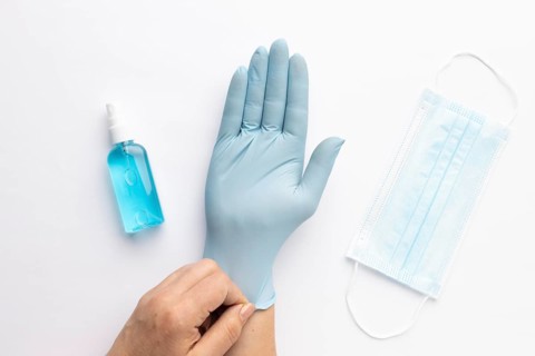 Top view hand putting glove with hand sanitizer medical mask 1