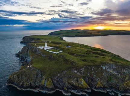 Sunset over Mull of Galloway Lighthouse from a drone