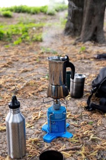 An espresso maker on a camping gas barbecue