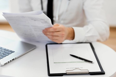 Close up doctor holding medical records