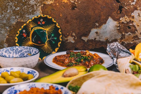 Different delicious mexican dishes rusty background with mexican hat