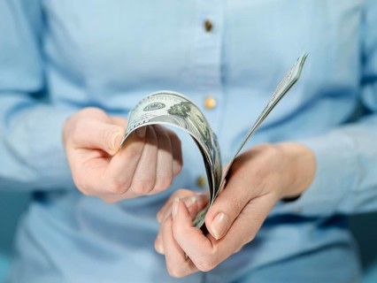 Front view person holding money