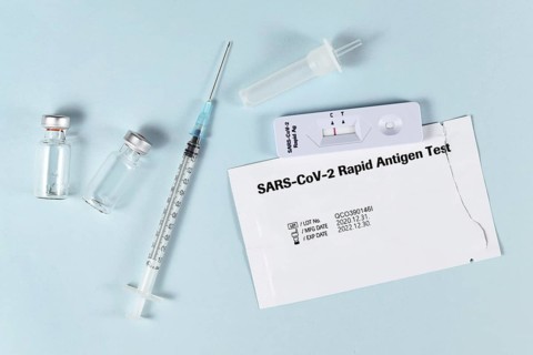 Tools to fight Corona Virus pandemic including rapid antigen test and vaccine vials with syringe