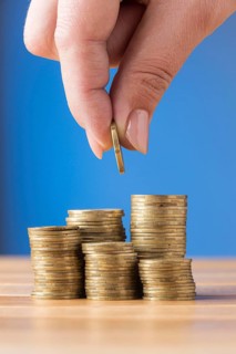 Person placing coin pile coins