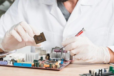 Close up male technician holding computer chip