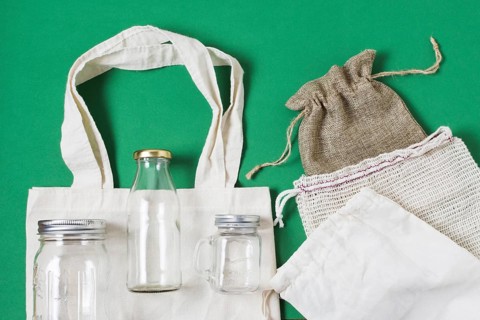Flat lay different zero waste products green background
