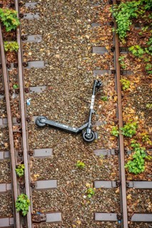 An electric scooter lies overturned between two railway tracks in Duesseldorf