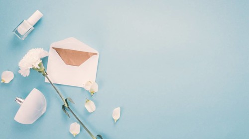 Envelope with white flower perfume table