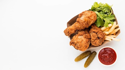 Top view fried chicken drumsticks with ketchup fries with copy space
