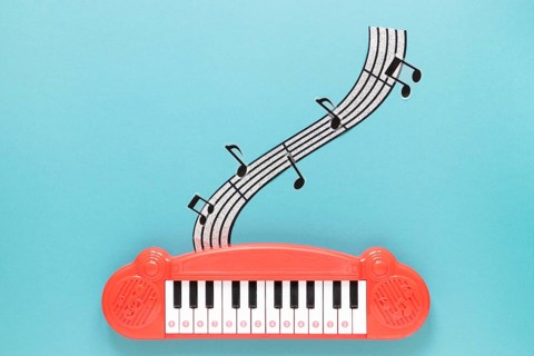 Top view piano toy with blue background