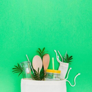 Top view reusable bag with glass bottle copy space