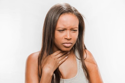 Portrait sick teenage girl with sore throat