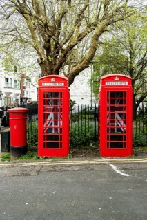 Two English red telephone boxes with Union Jack flags