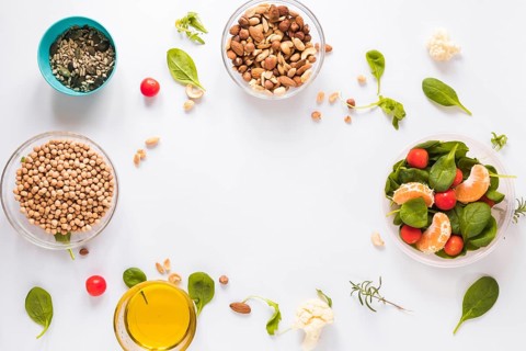 Top view healthy ingredients bowls white background with blank space text