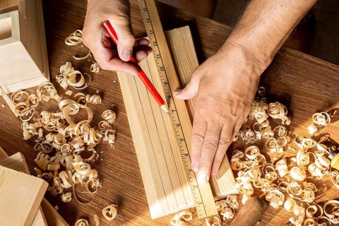 Carpenter measuring with ruler pencil