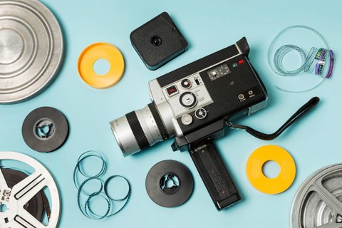 Elevated view film reel film strips camcorder blue background