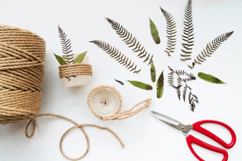 Leaves scissor jute string wrapped candles white background