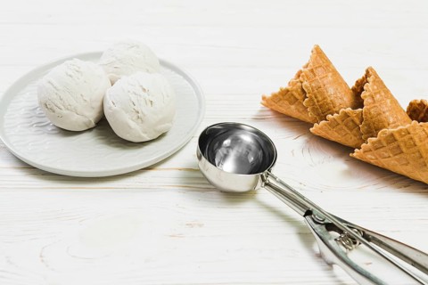 Scoop near ice cream balls waffle cones