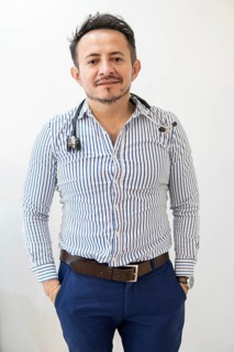 Portrait of latin doctor posing in his office