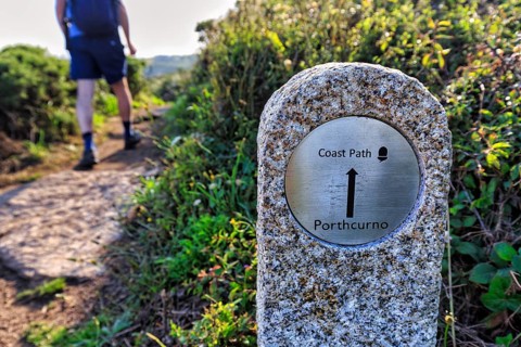 Walkers next to waymarker