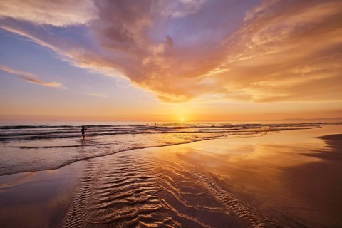 Atlantic ocean sunset with surging waves at Fonte da Telha beach