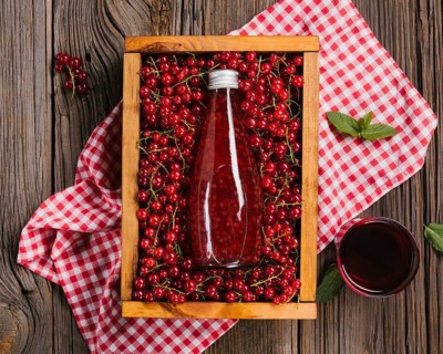 Cranberry juice bottle wooden background