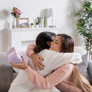 Mom hugging girl gift