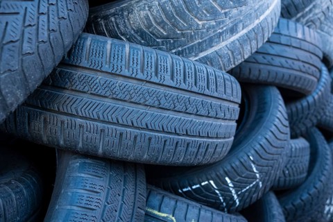 Pile of worn old tyres from passenger cars