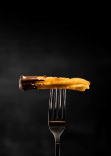 Minimalist fried churros fork front view