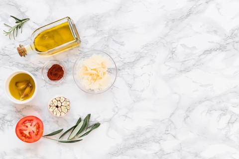 Various ingredients with oil white marble background