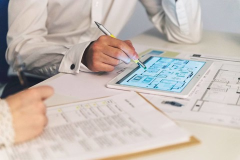 Crop people working with plans tablet