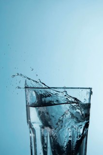 Clear glass with water splashing