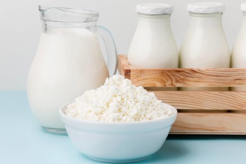 Close up milk jug with fresh cottage cheese