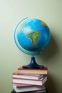 Stacked books with globe