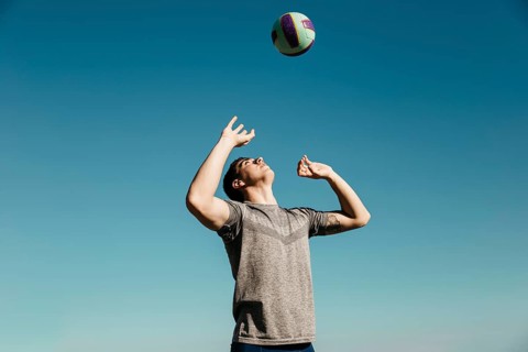 Man playing volleyball beach