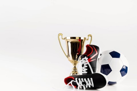 Football composition with shoes ball trophy