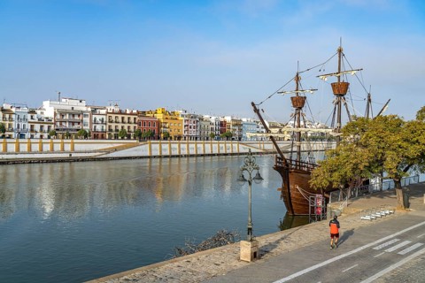 Replica of the Nao Victoria 500 and the colourful houses of the Triana district on the Guadalquivir River