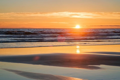 Atlantic ocean sunset with surging waves at Fonte da Telha beach