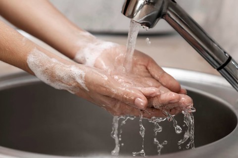 Person washing hands sink