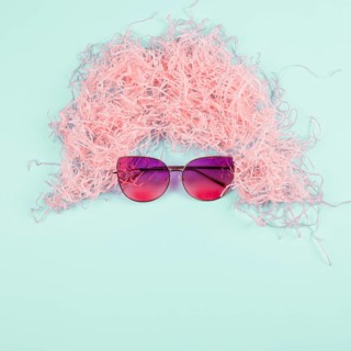 Pink shredded paper wig sunglasses mint background
