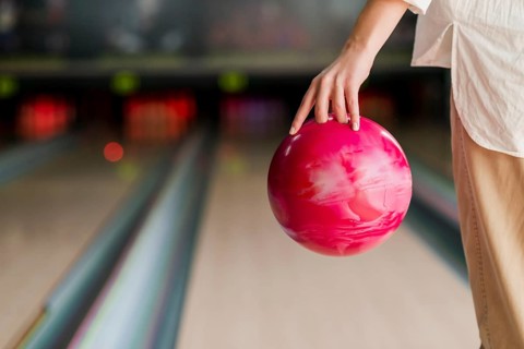 Person holding red bowling ball