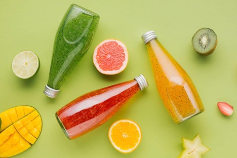 Colorful juice bottles fruit slices